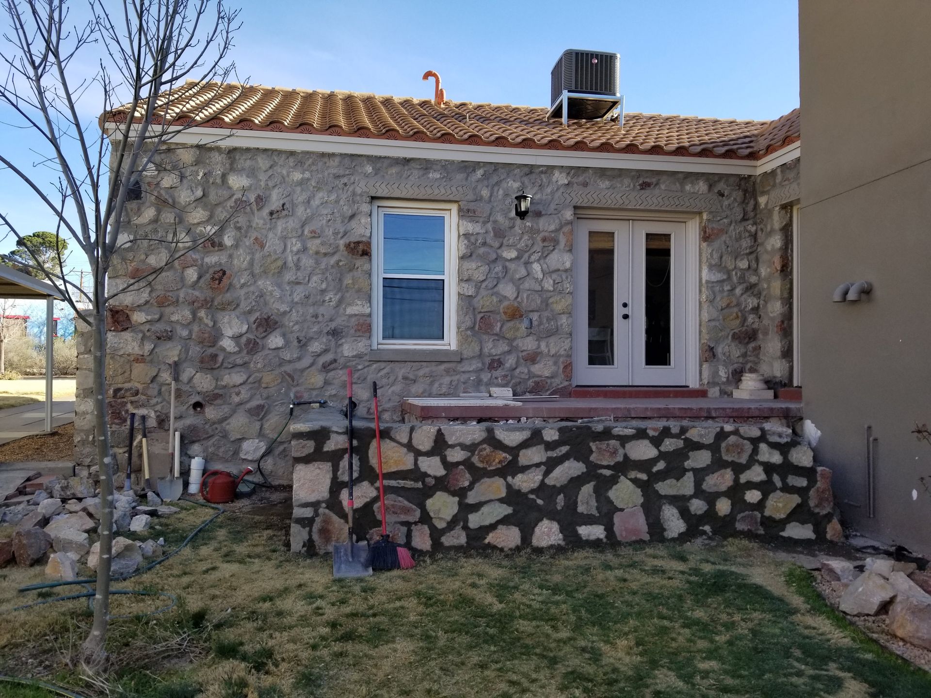 A stone house with a white door and a window