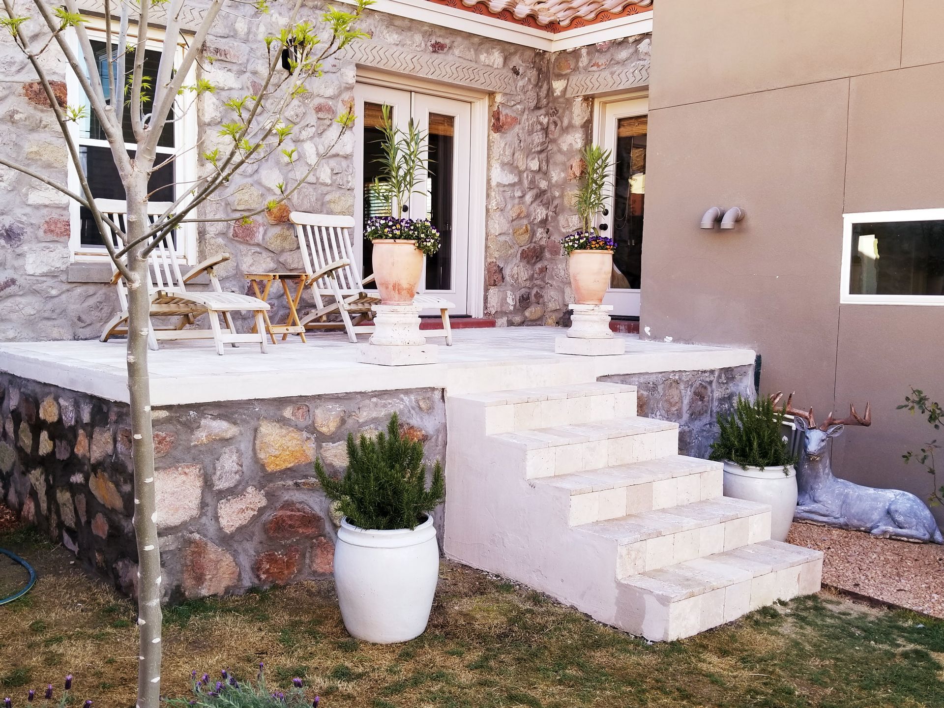 A stone house with stairs leading up to a porch