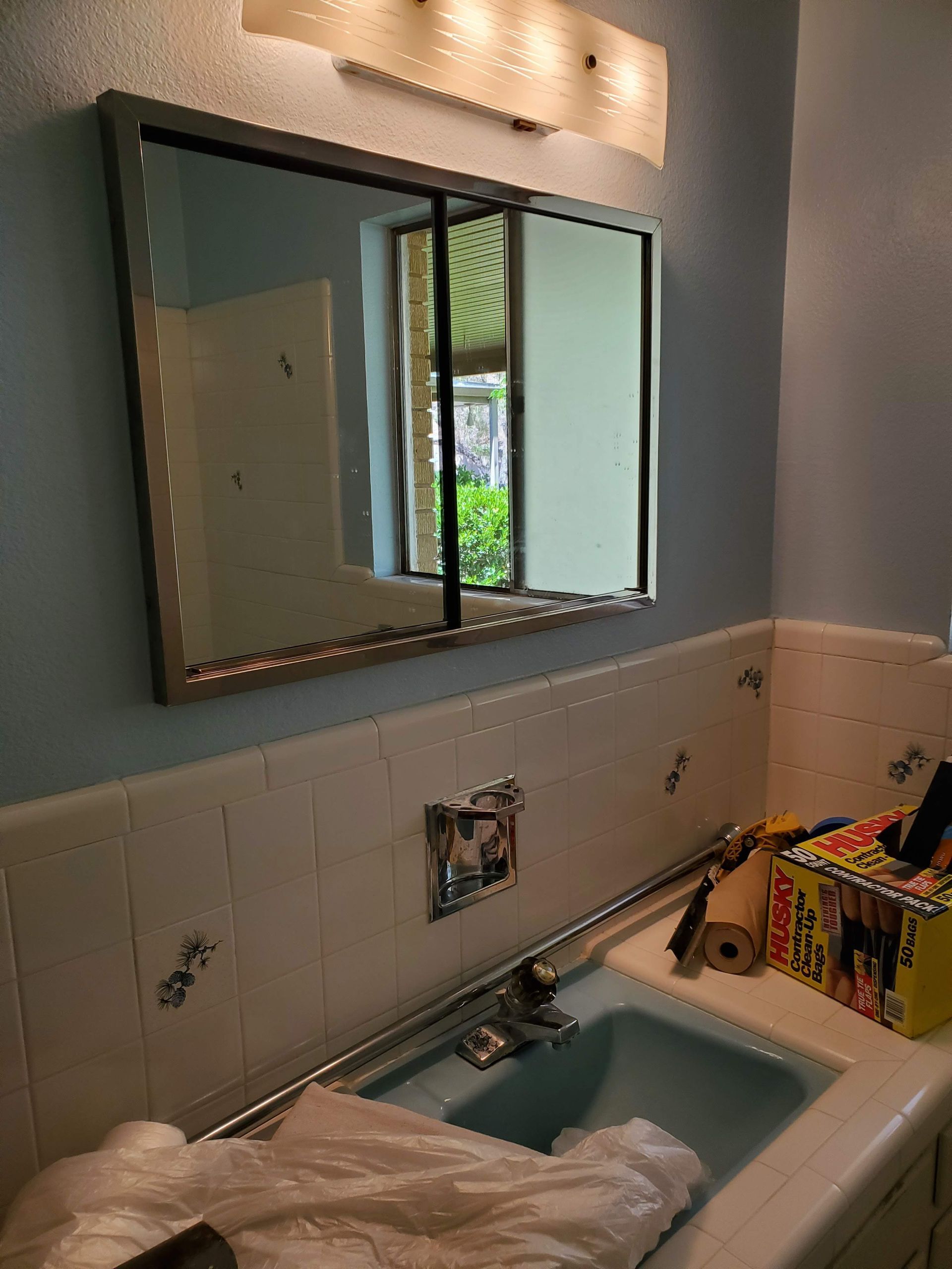 A bathroom with a sink and a mirror.