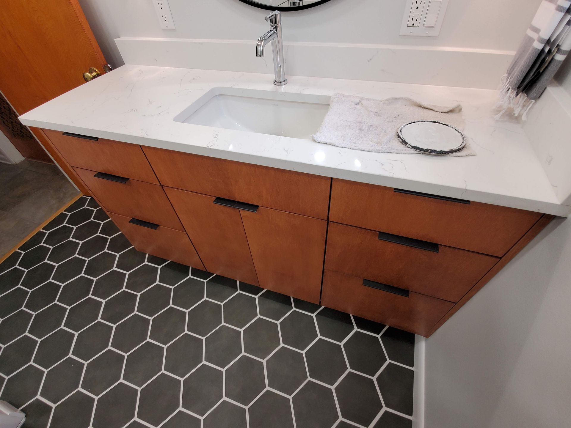 A bathroom vanity with a sink and a mirror