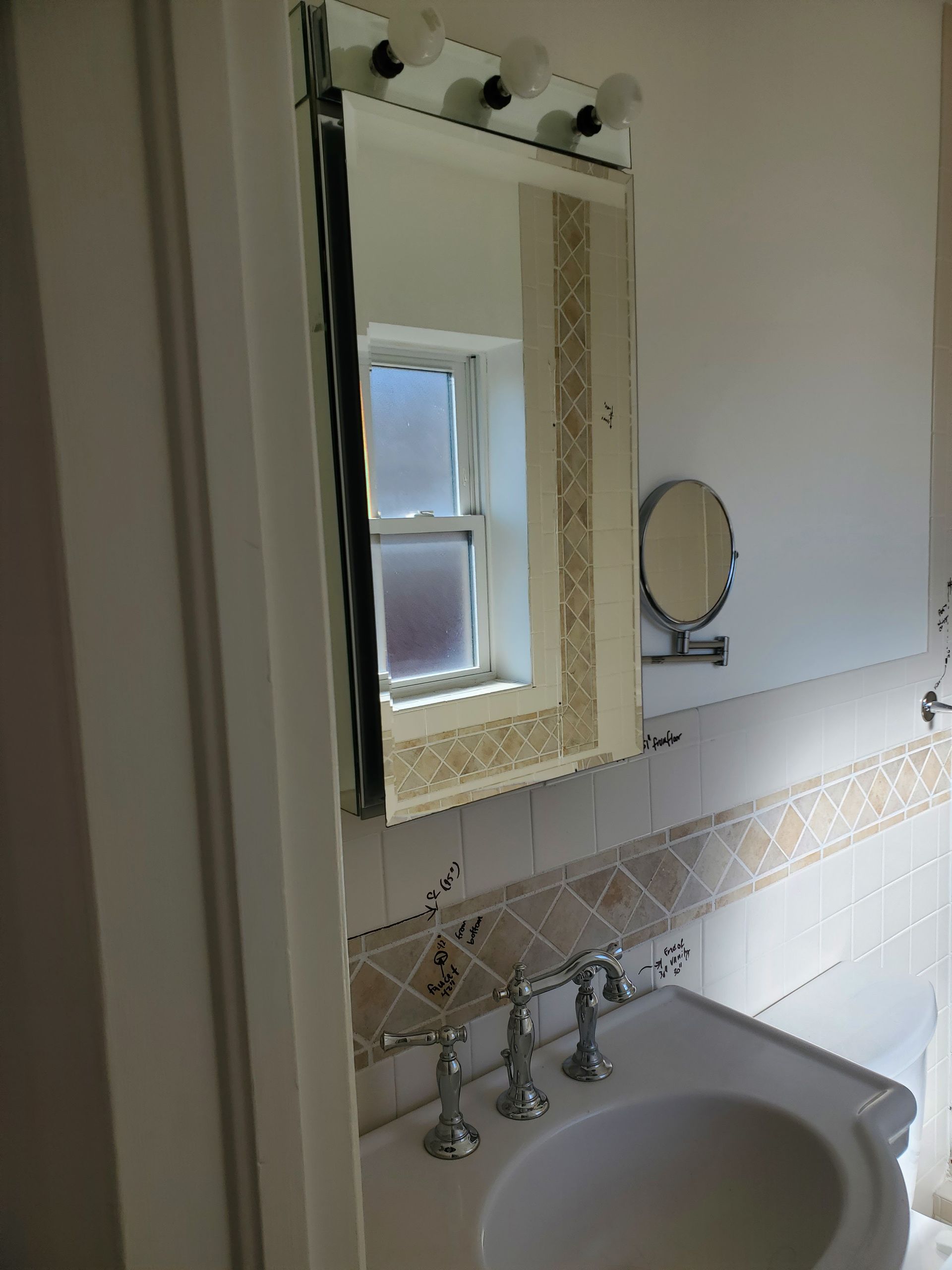 A bathroom with a sink a mirror and a window