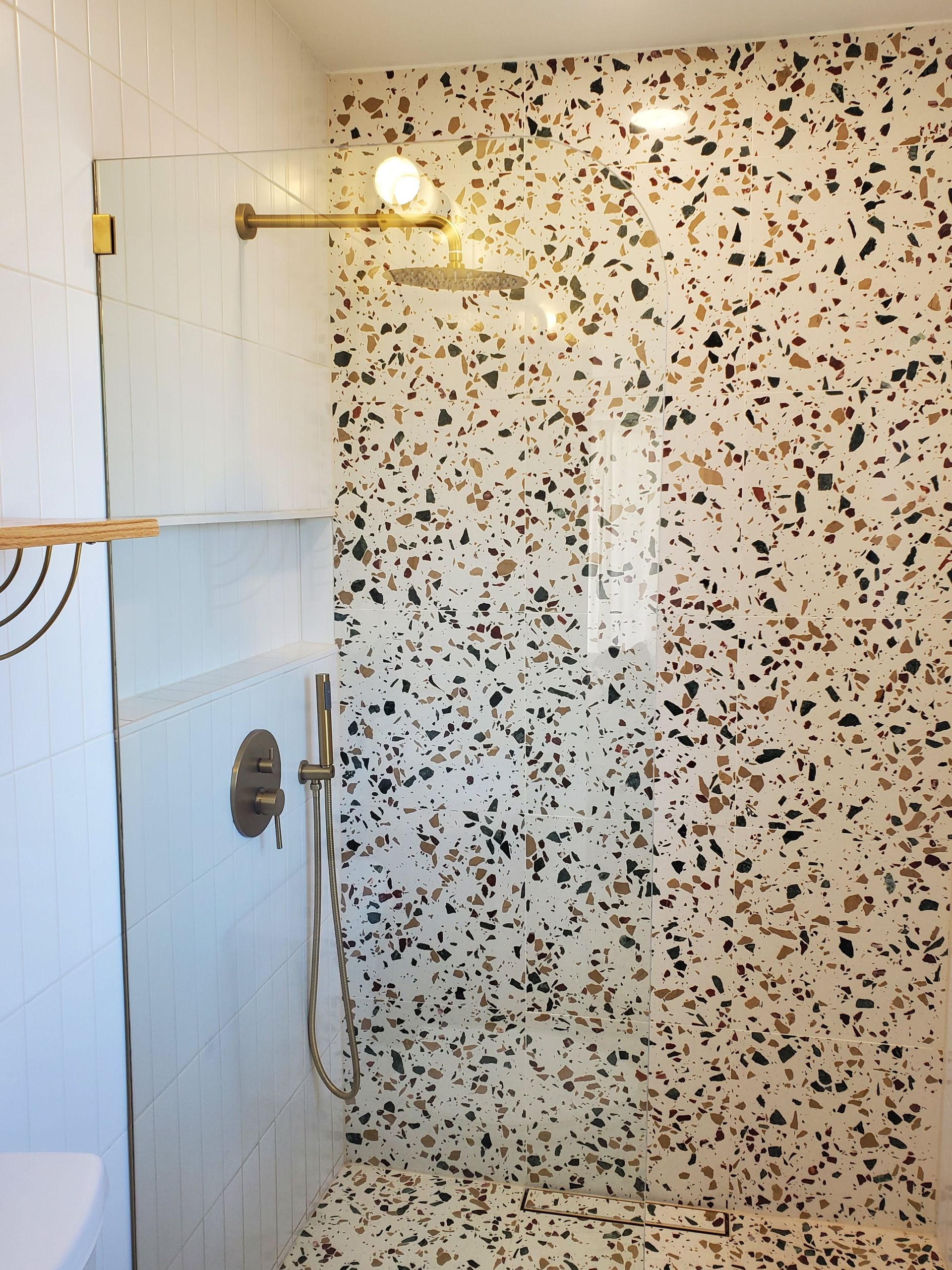 A bathroom with a shower and a toilet.