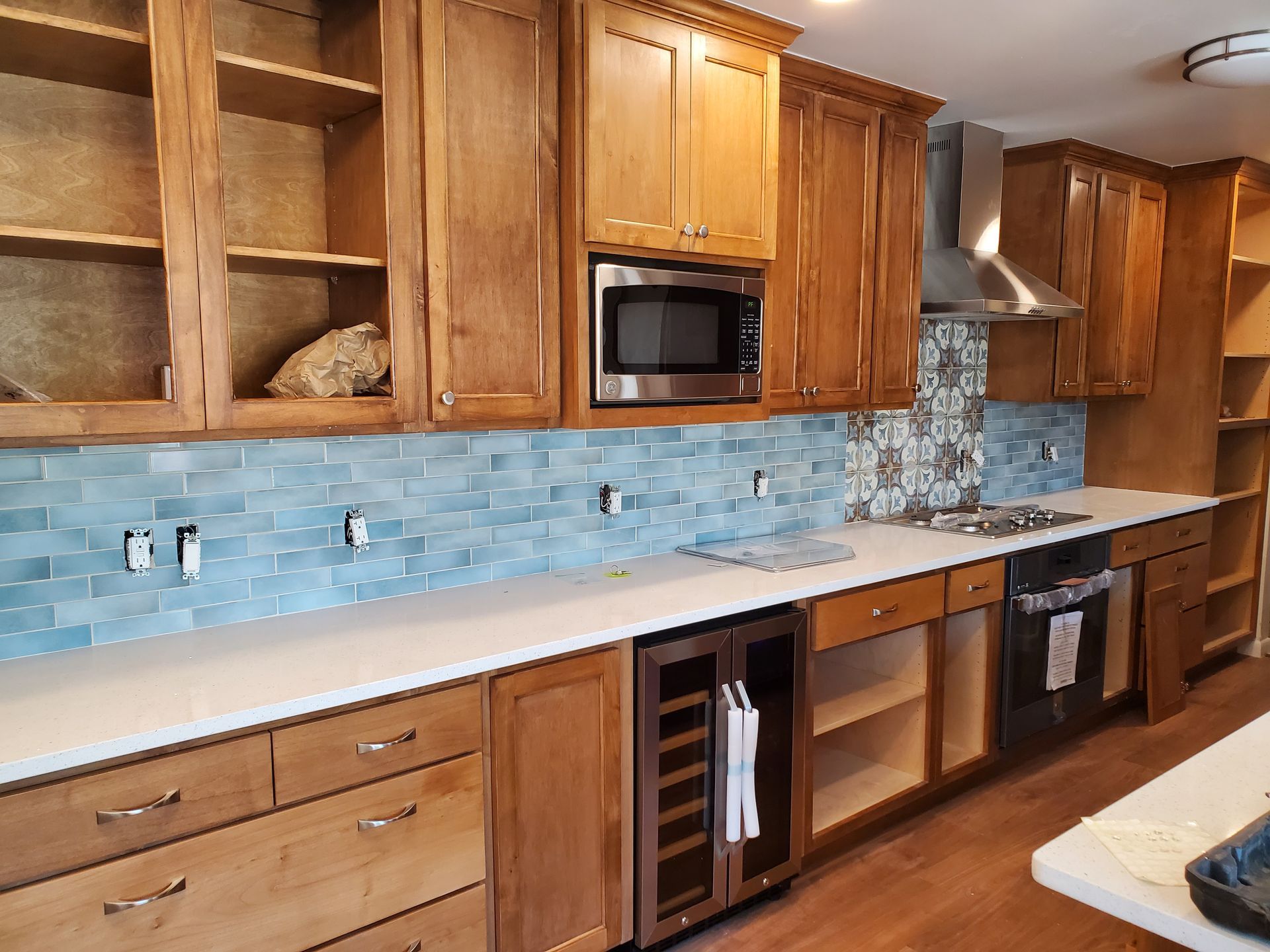 A kitchen with wooden cabinets and stainless steel appliances