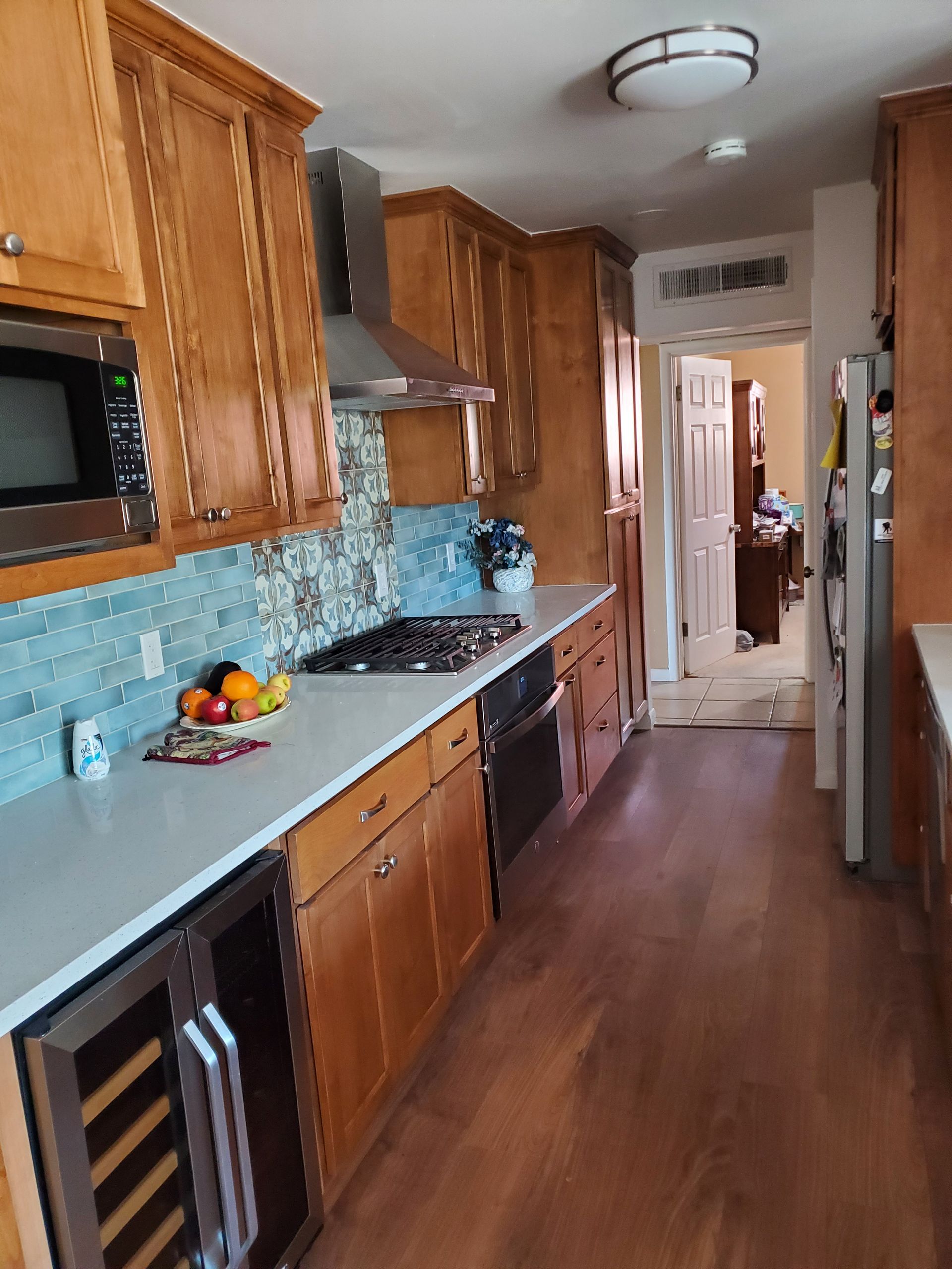 A kitchen with wooden cabinets and stainless steel appliances