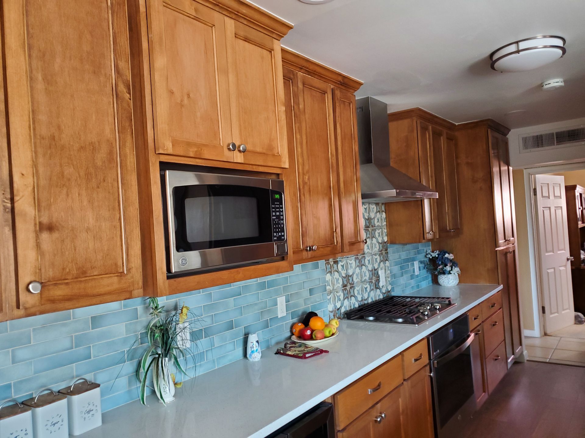 A kitchen with wooden cabinets and stainless steel appliances