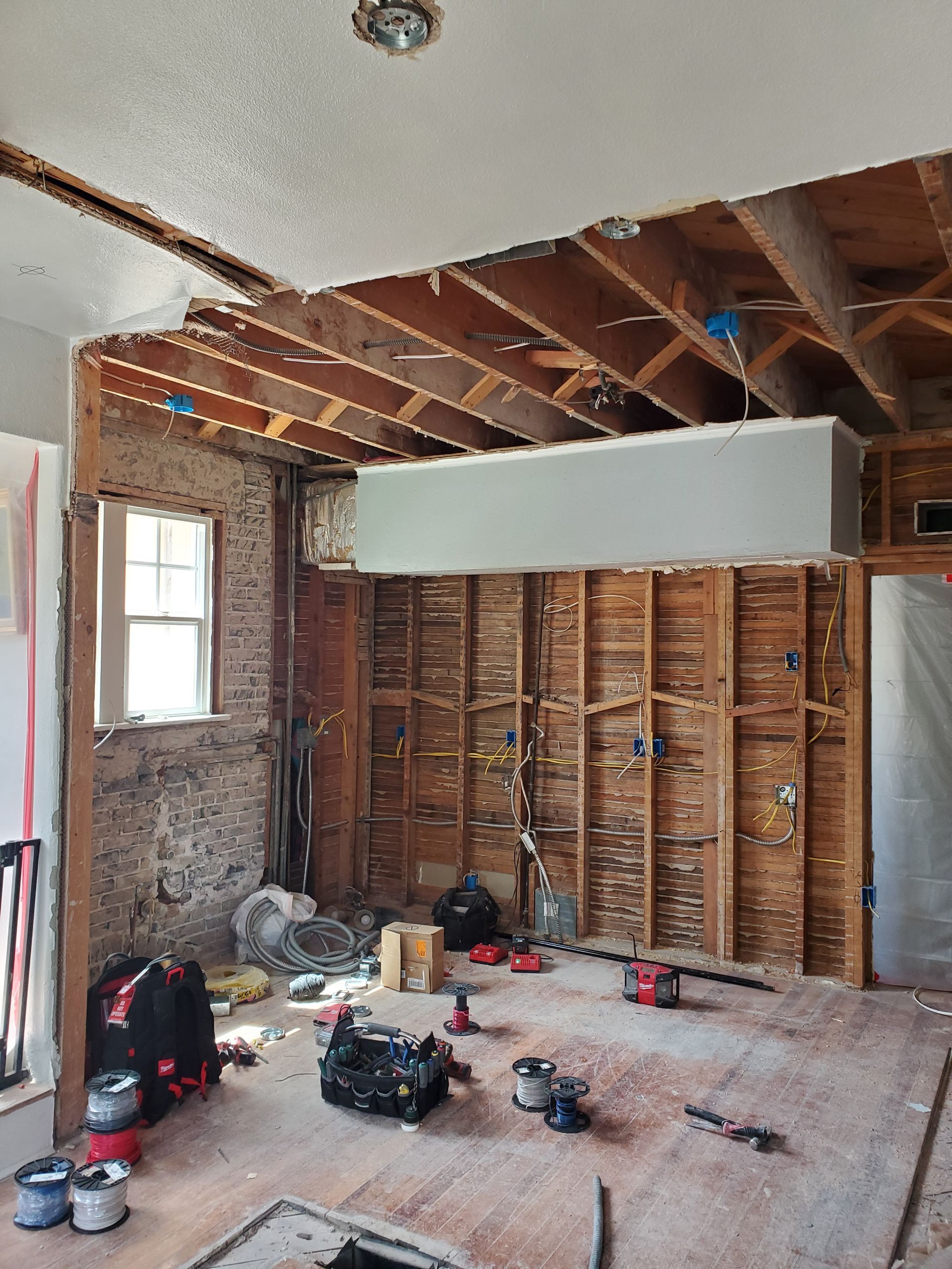 A room that is being remodeled with a lot of tools on the floor.