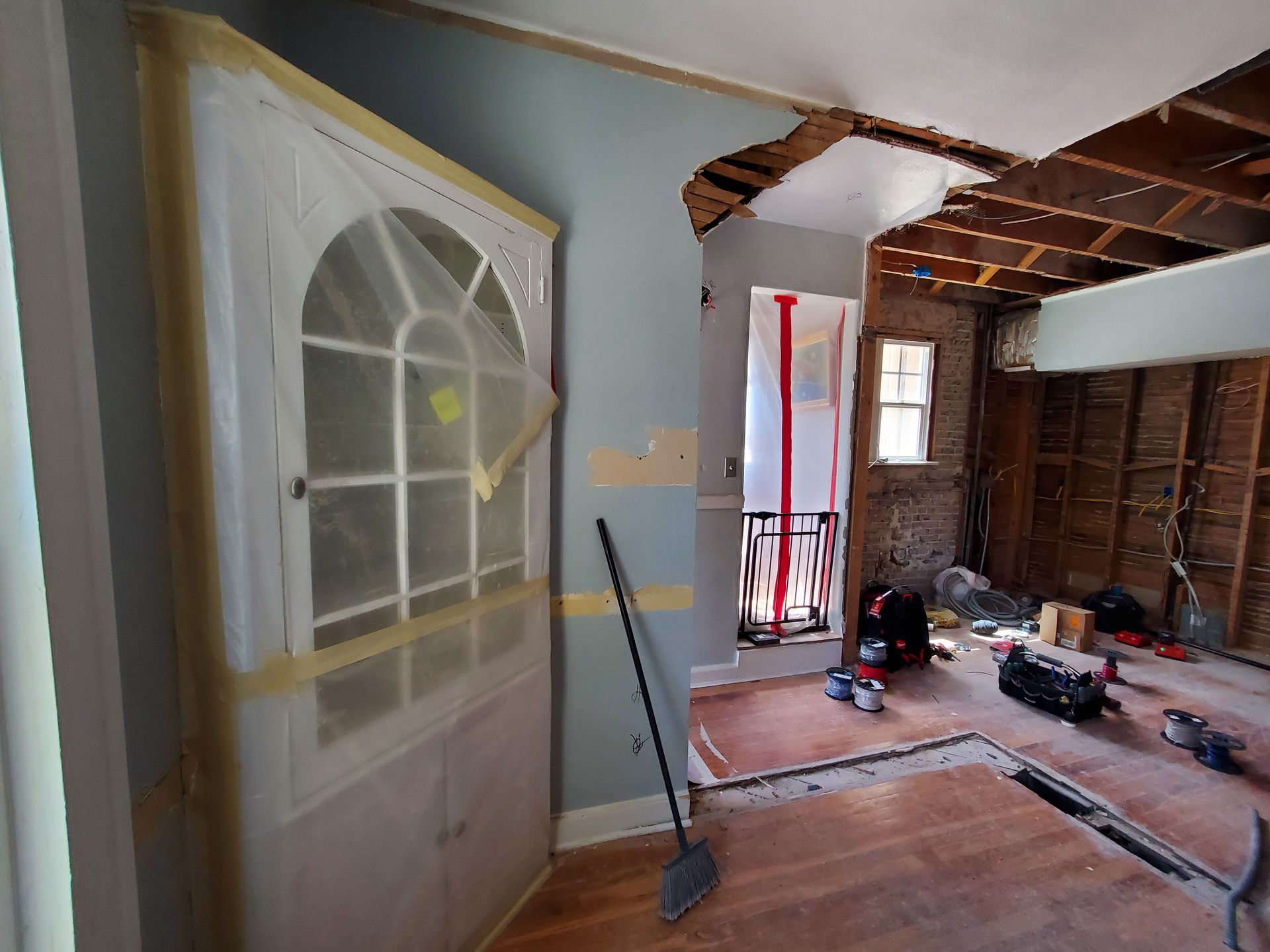 A room with a door and a broom in it