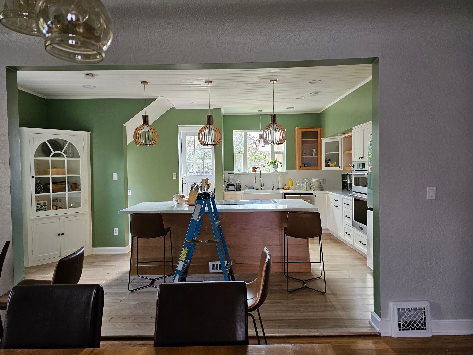 There is a ladder in the middle of the kitchen.