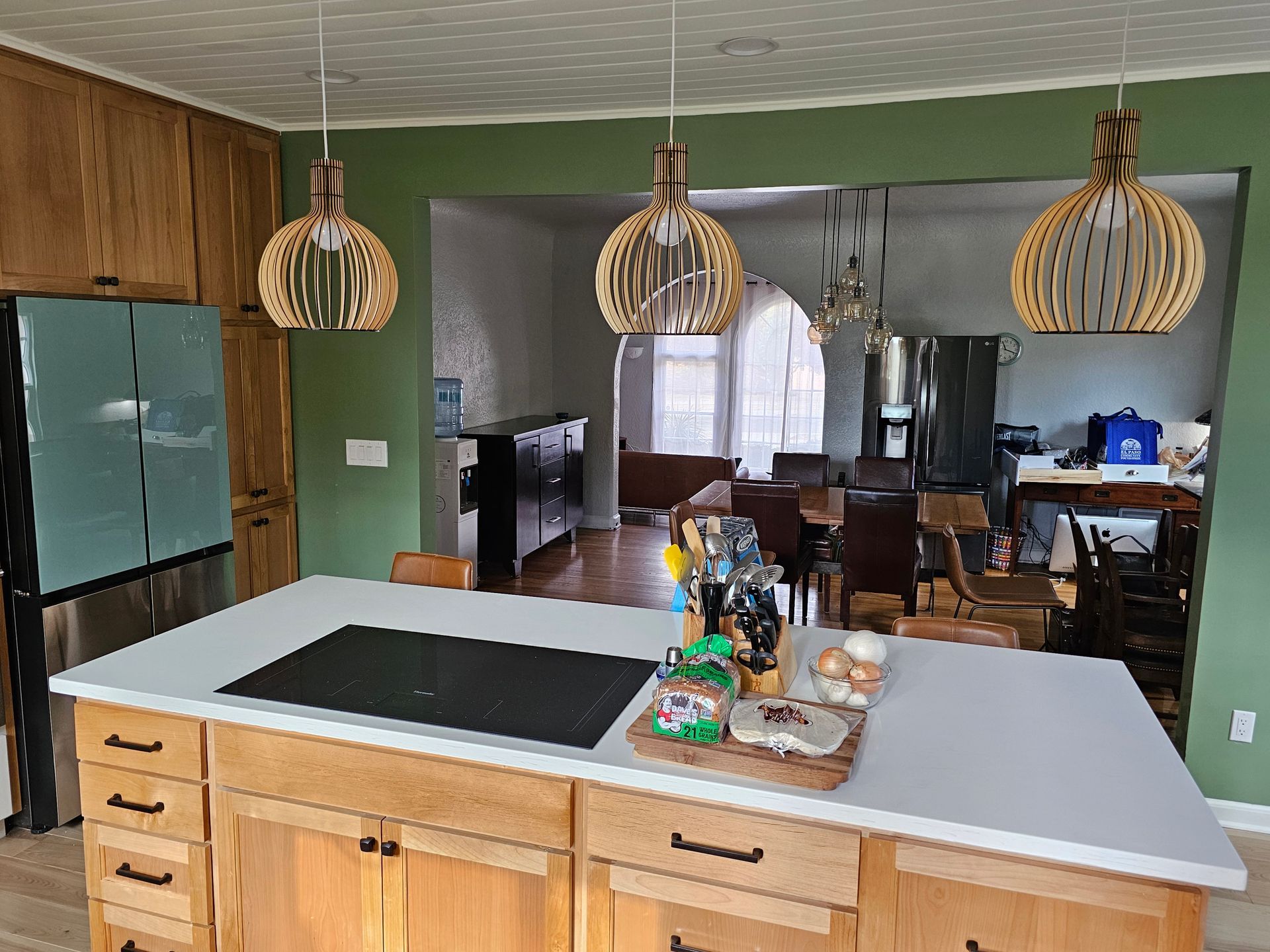 A kitchen with a large island and a stove top oven.