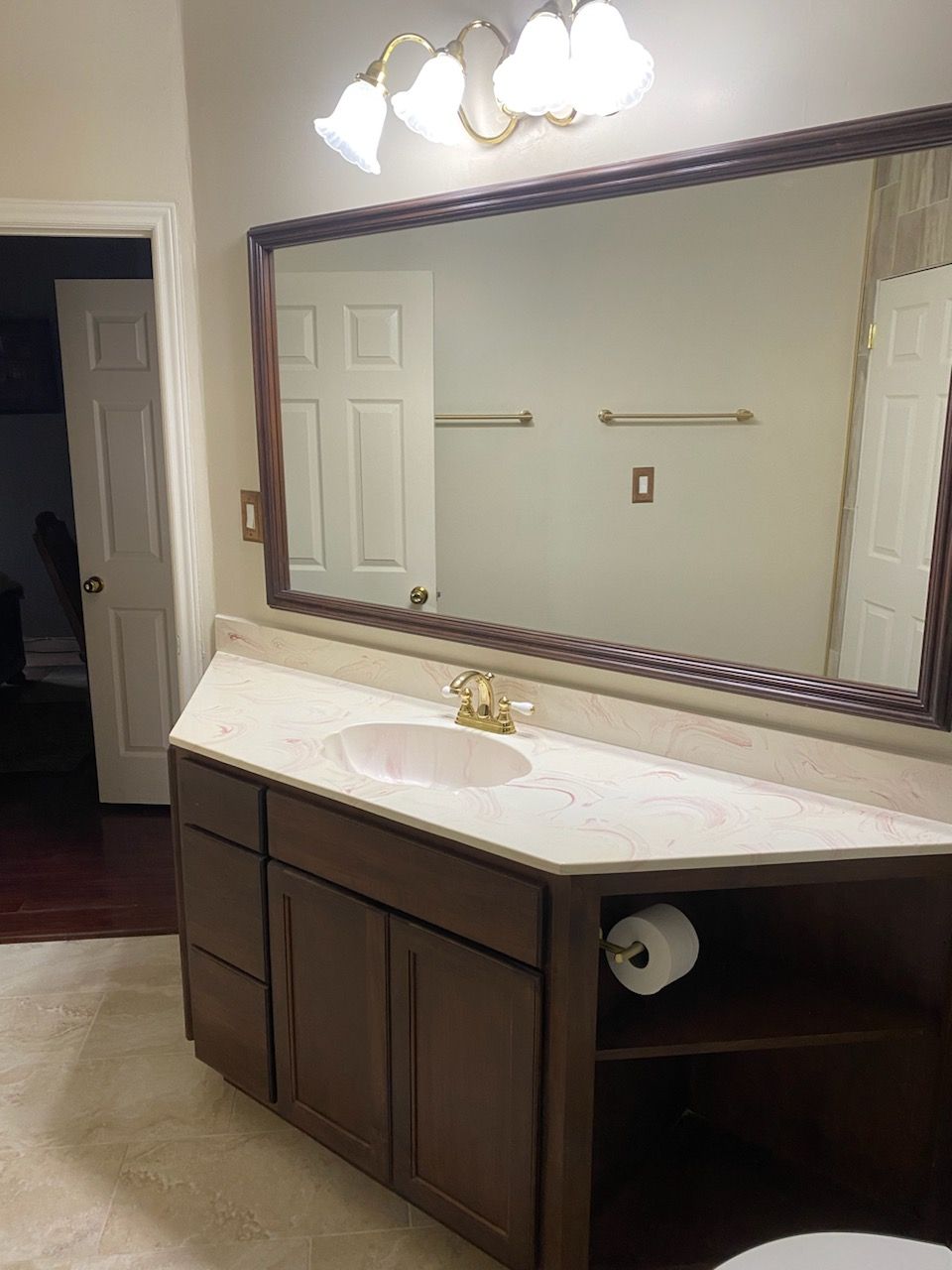 A bathroom with a large mirror and a sink