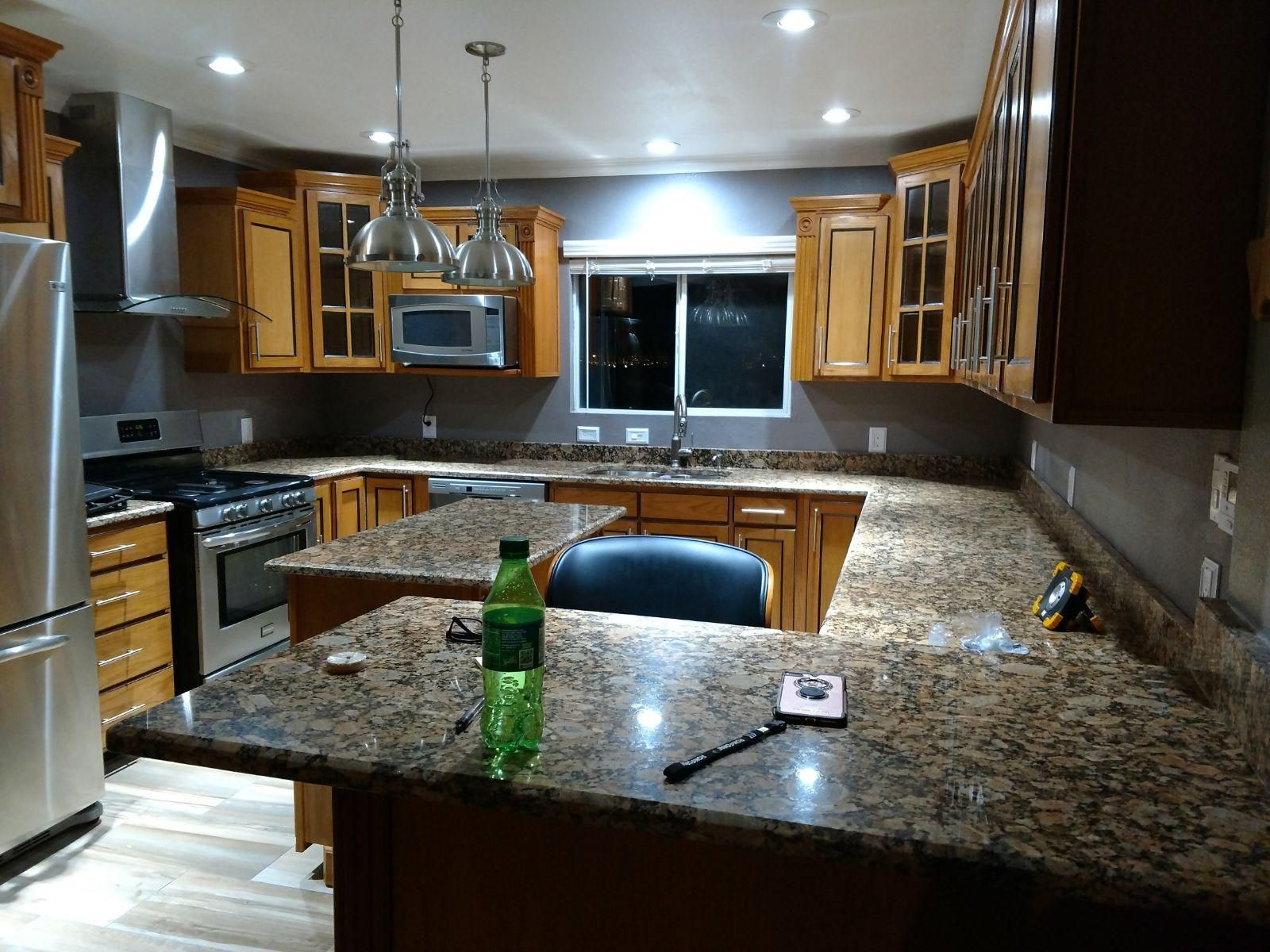 A kitchen with granite counter tops and stainless steel appliances