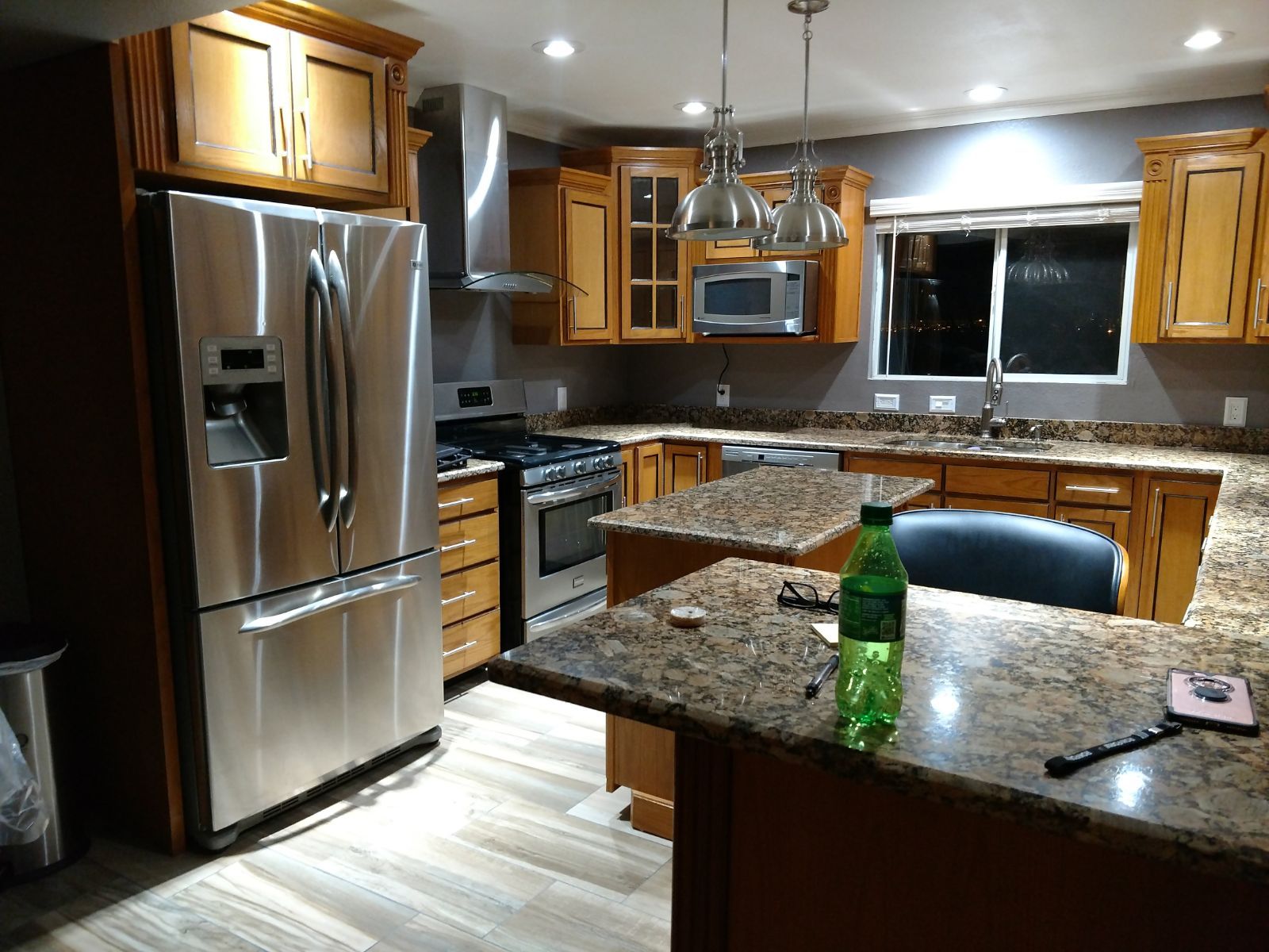 A kitchen with stainless steel appliances and granite counter tops.