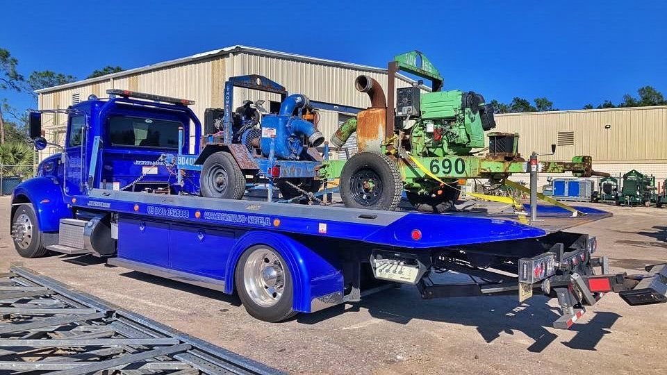 Efficient construction equipment hauling by Naples Towing and Recovery in Naples, FL.