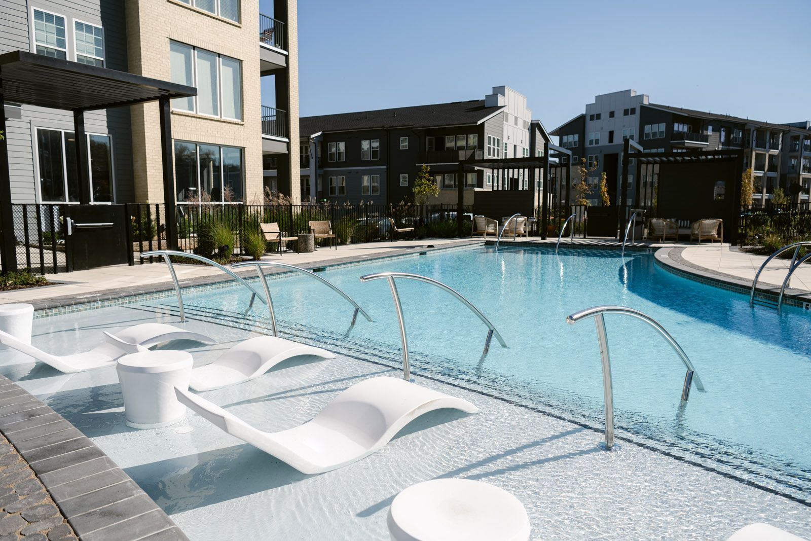 Lounge chairs on the sundeck of the swimming pool at Livano Nations.
