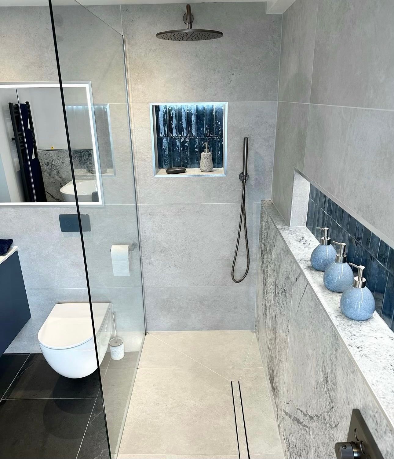 A bathroom with a toilet a sink and a shower