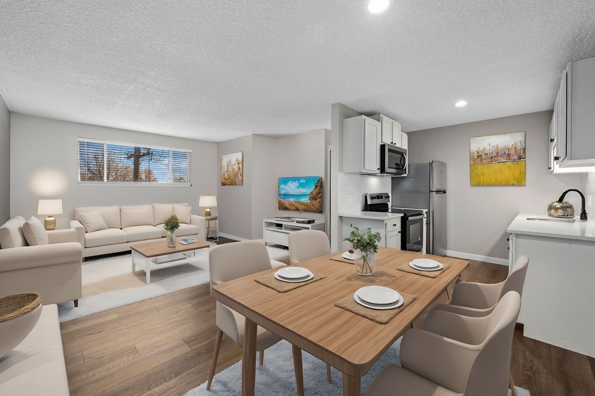 Photo of  a dining area in the foreground, and a living room in the background