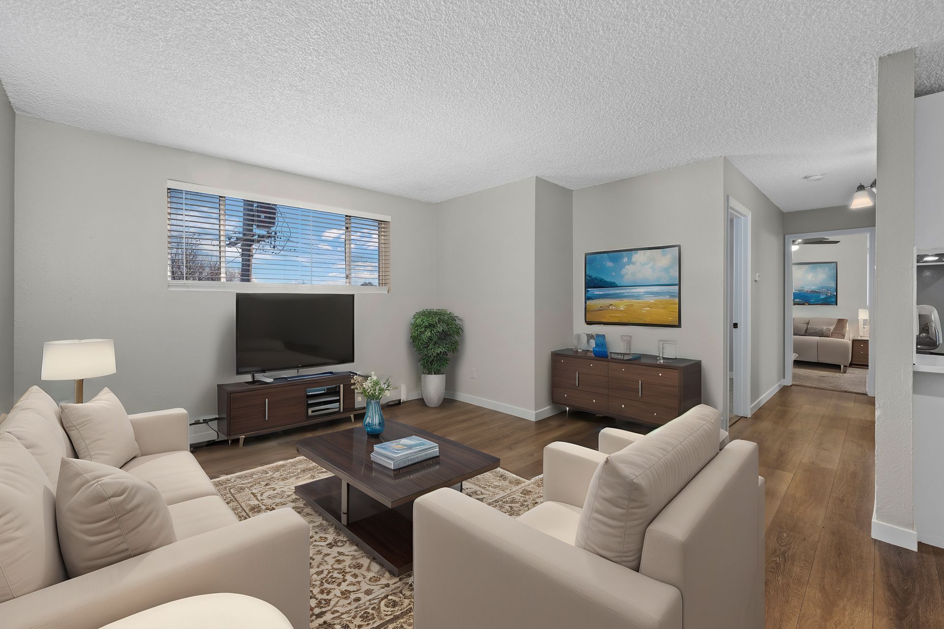 Photo of  a living room, showing a bedroom in the background