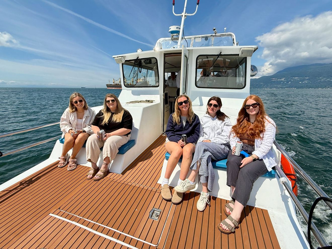 Passengers sitting on the bow deck on our Vancouver Sightseeing Boat Tour
