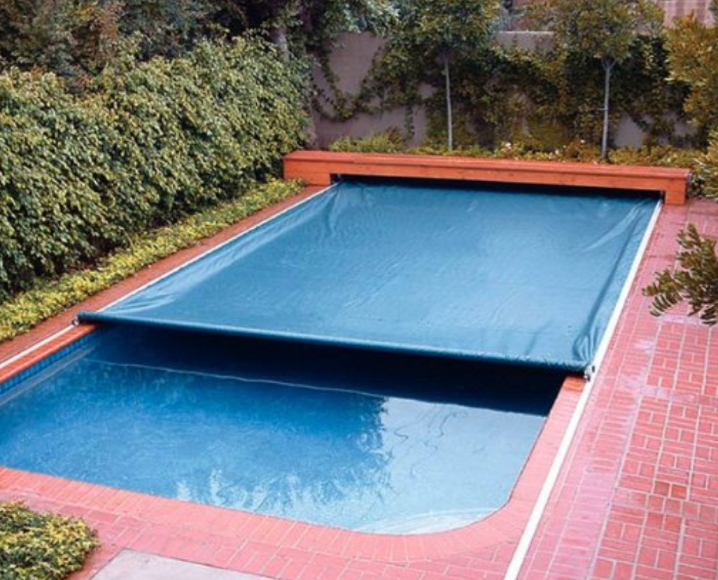 A large swimming pool with a blue cover on it