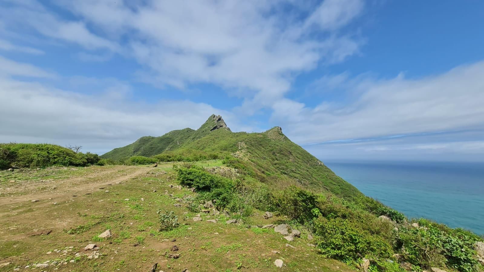 Khareef season in Salalah, Dhofar - lush green mountains and turquoise sea