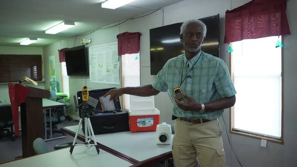 Classroom: Students with diverse backgrounds raise hands, engaged in learning.
