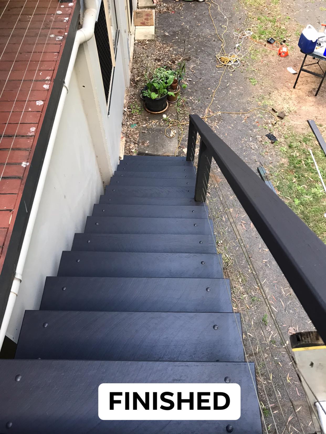 A Man Painting A Wall — Property Maintenance & Garden Care in Beerwah, QLD