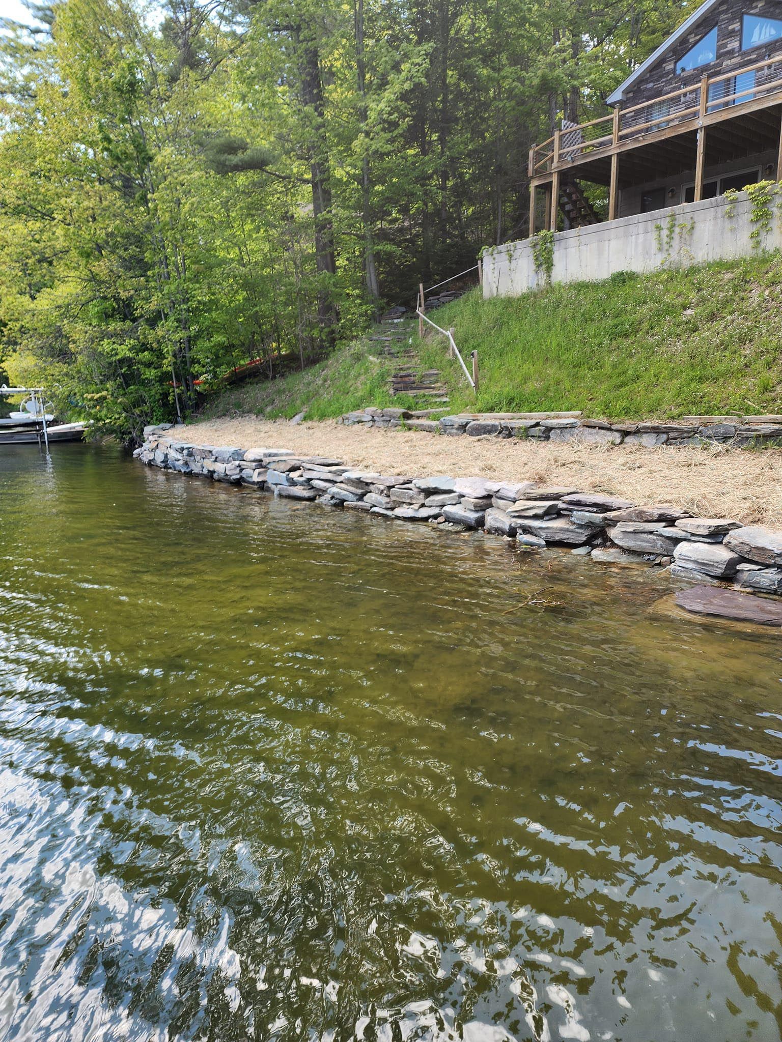 A large body of water with a house in the background.