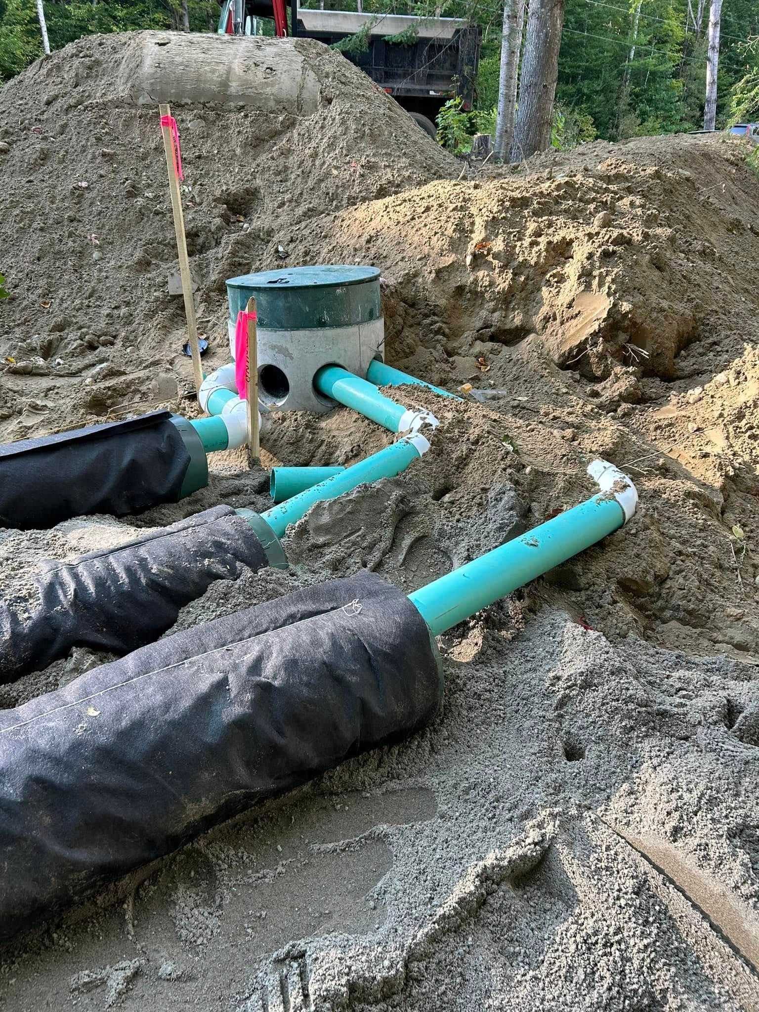 A pile of dirt with a bunch of pipes in it.