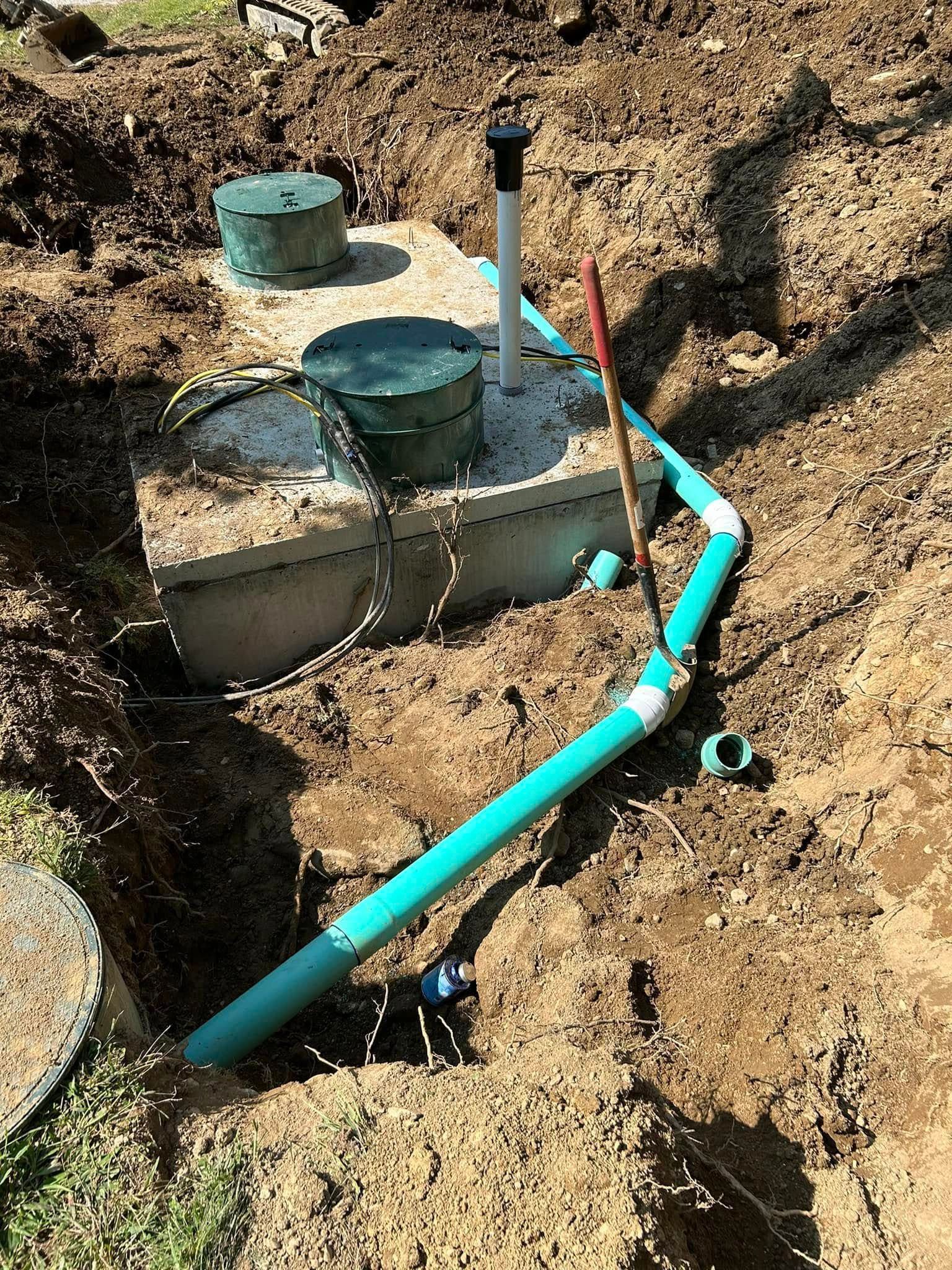 A septic tank is being installed in a hole in the ground.