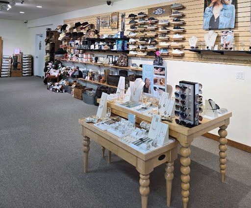 Interior of a store with jewelry displays and shelves of accessories. Soft lighting, neutral colors.