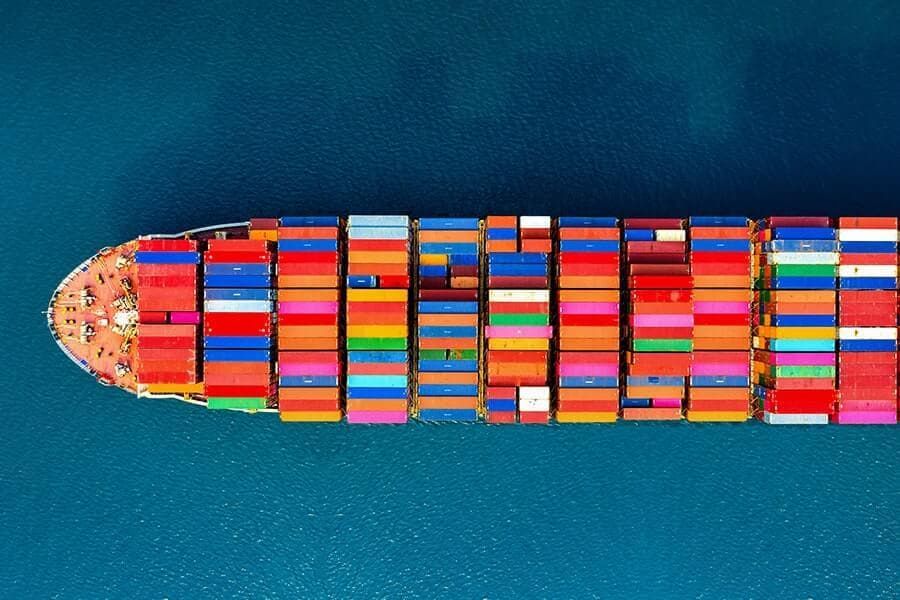 An aerial view of a large container ship in the ocean.