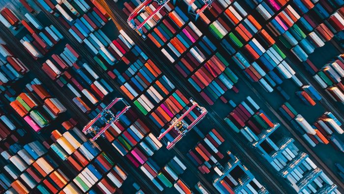 An aerial view of a large container port filled with lots of colorful containers.