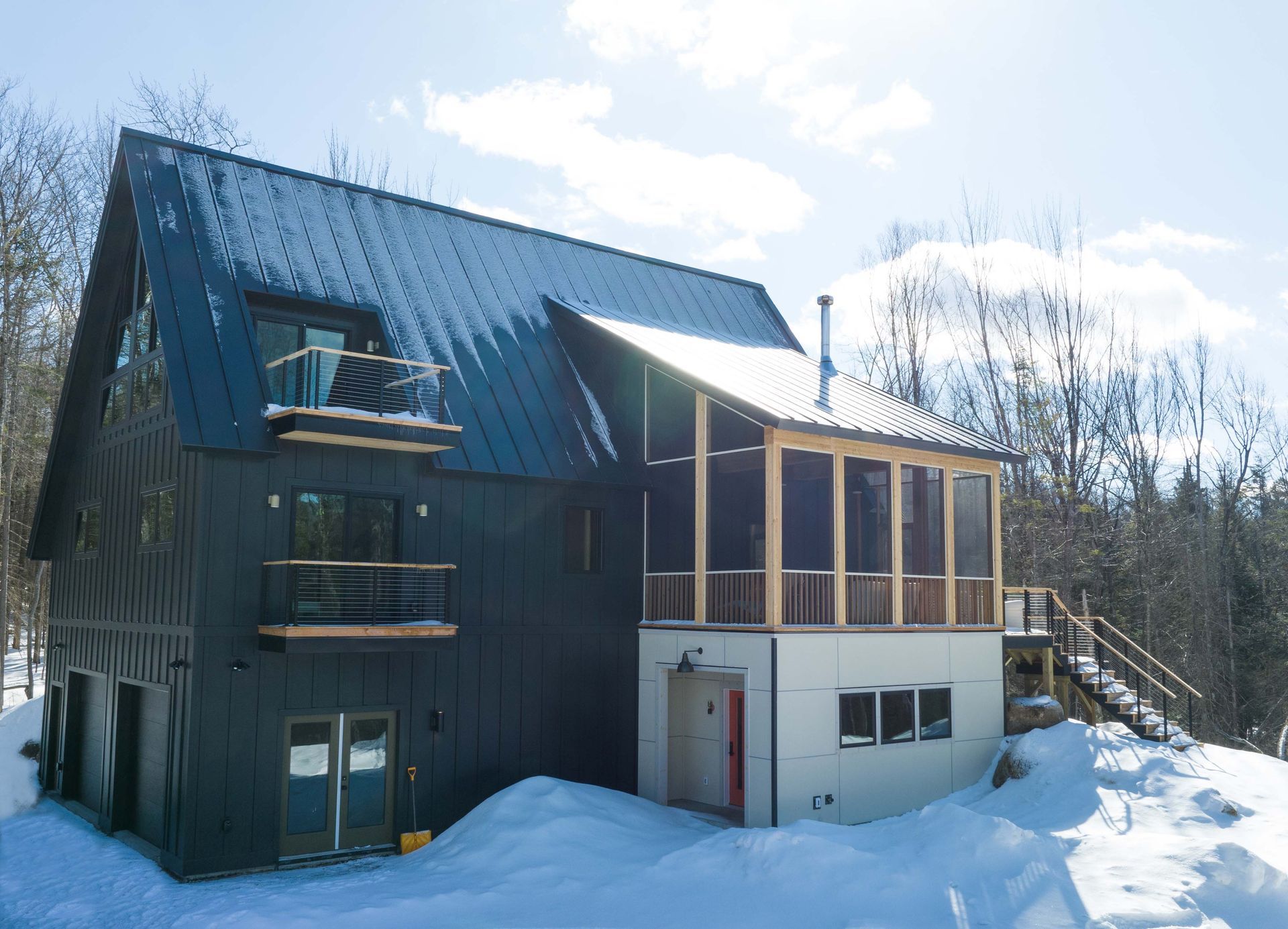 A large house with a screened in porch in the snow