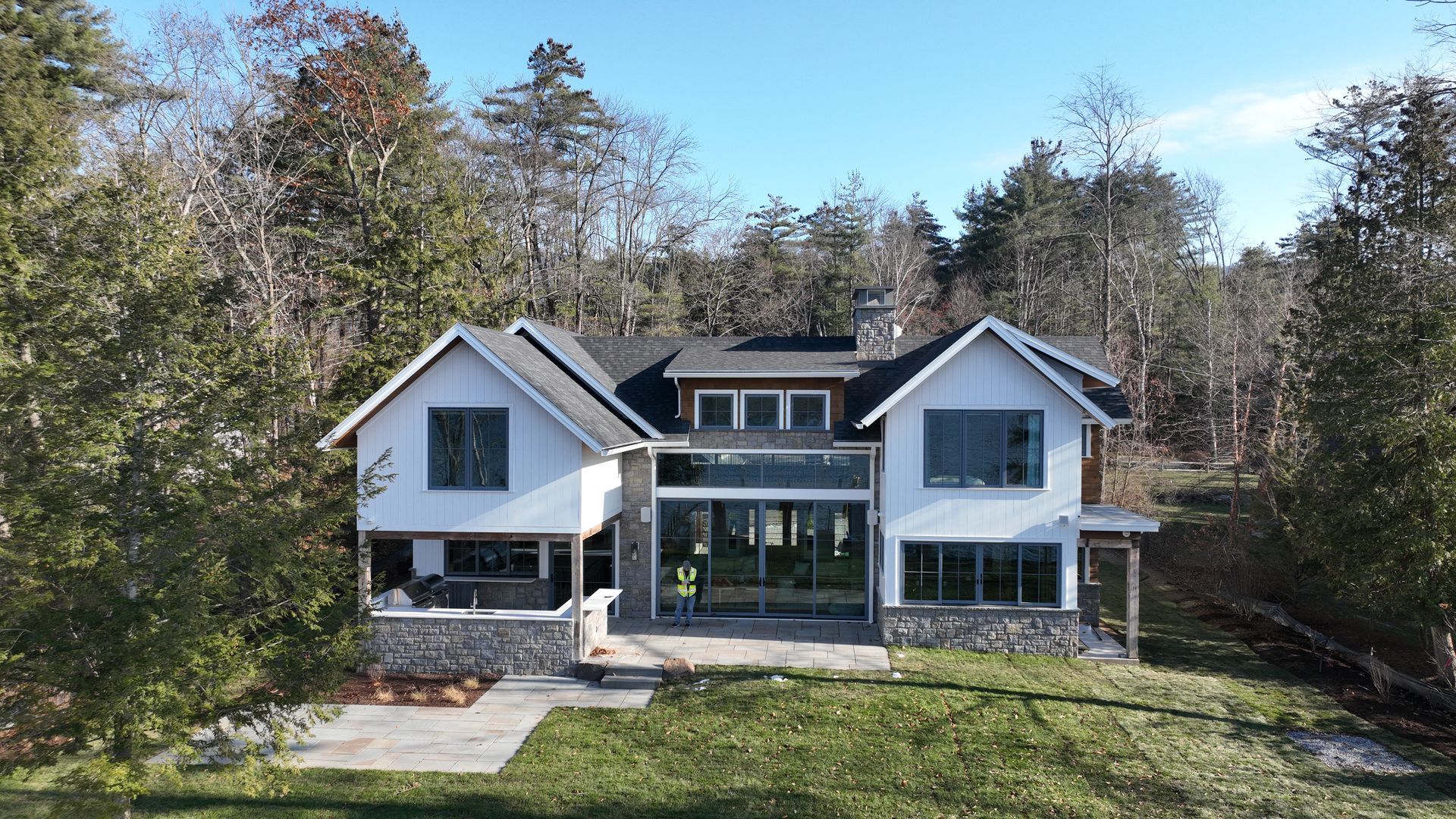 An aerial view of a large white house surrounded by trees.