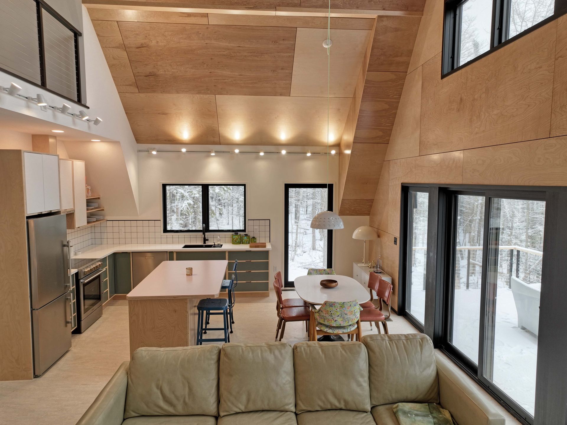 A living room with a couch and a kitchen in the background