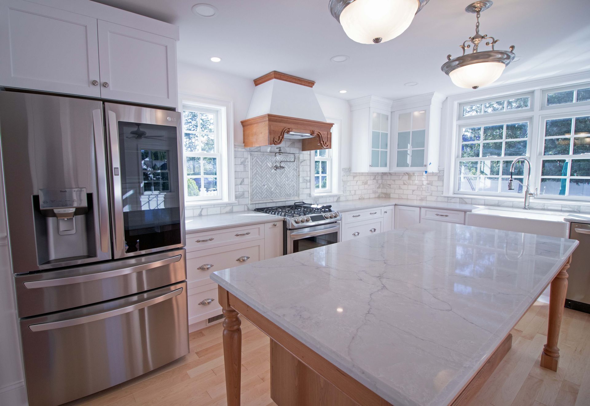 A kitchen with stainless steel appliances and a large island.