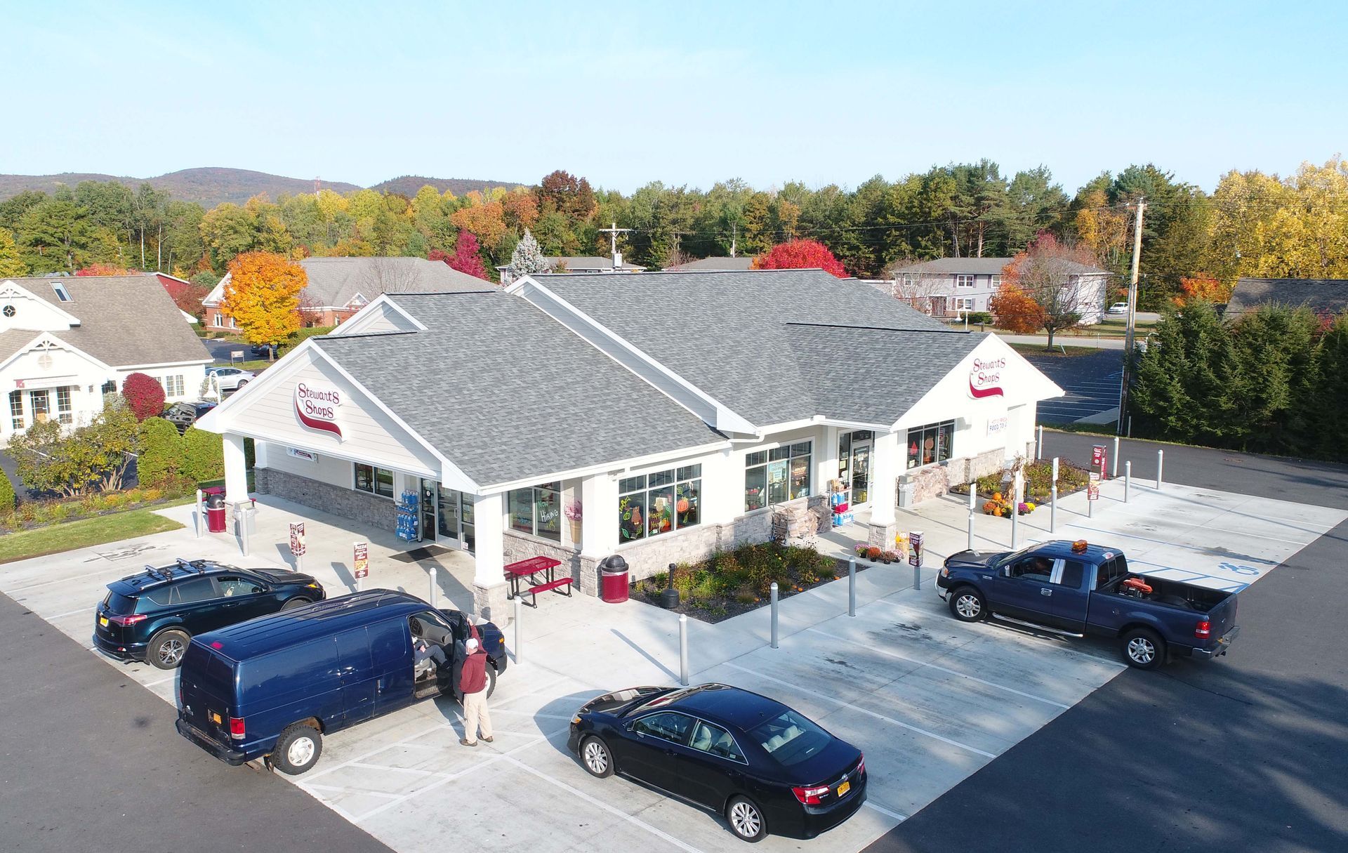 An aerial view of a building with cars parked in front of it