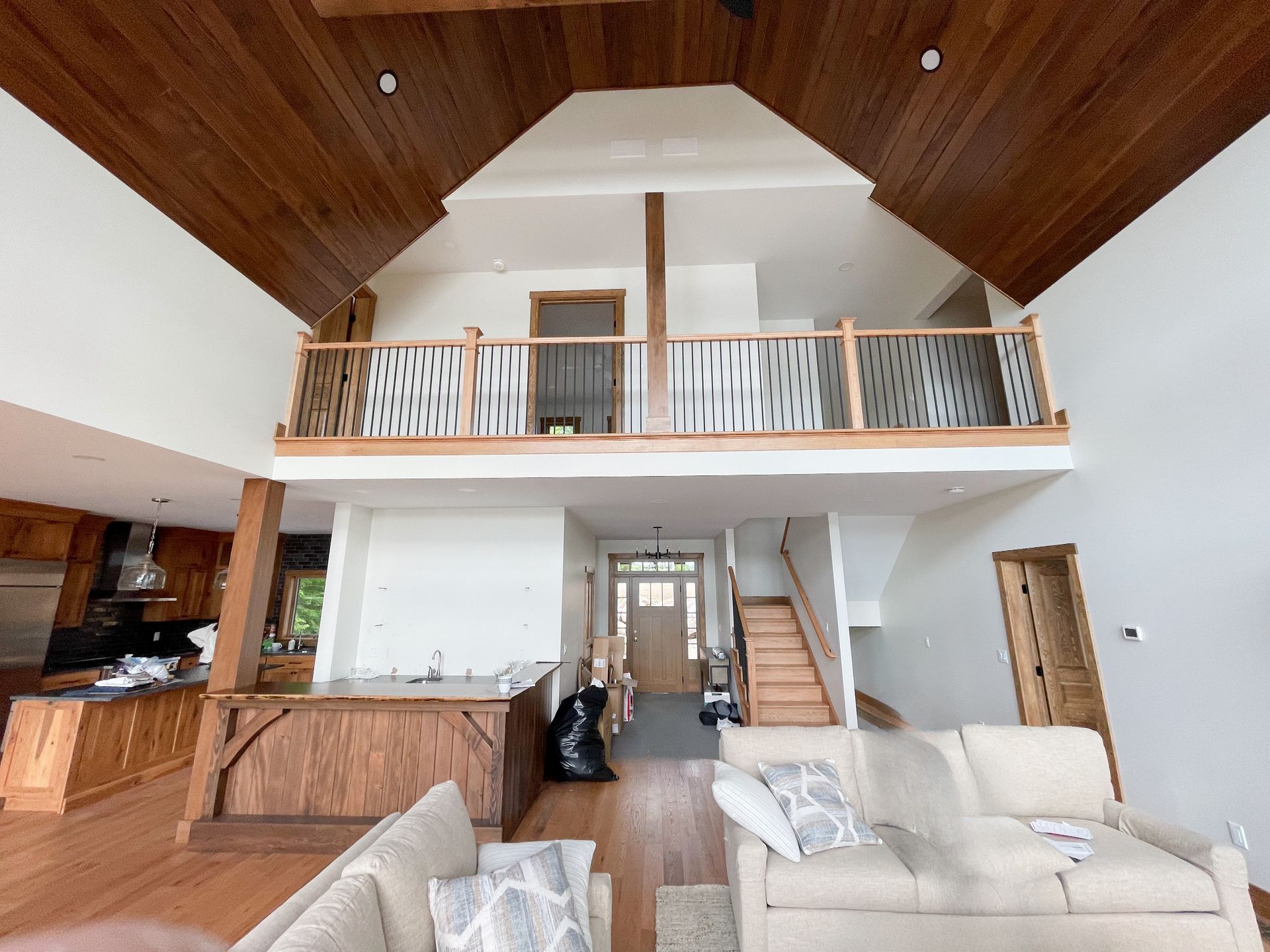 A living room with a couch and stairs leading to the second floor