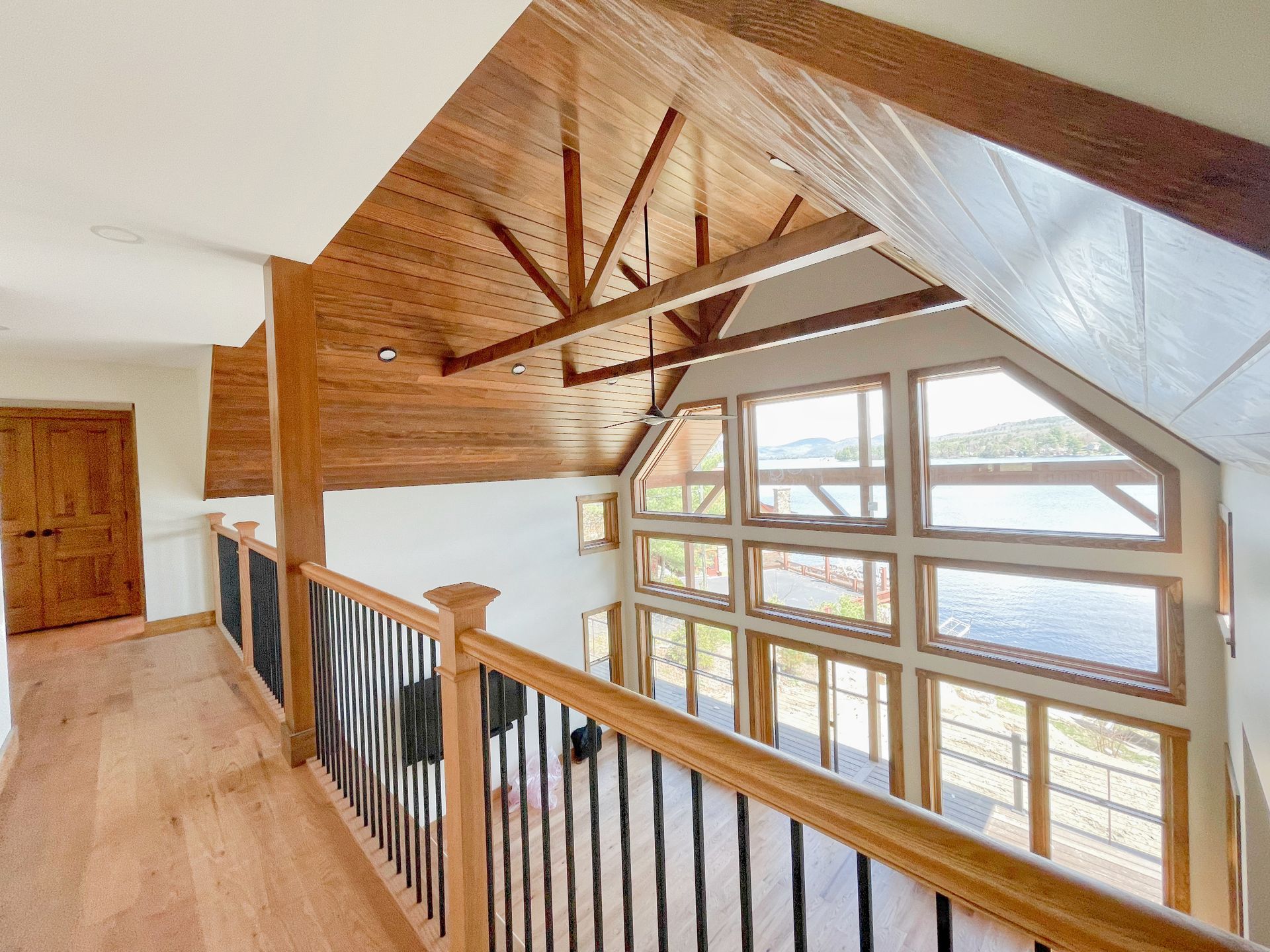 A hallway with a railing and lots of windows