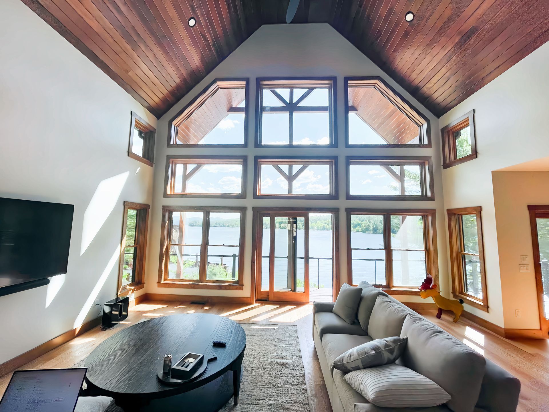 A living room with a lot of windows and a couch
