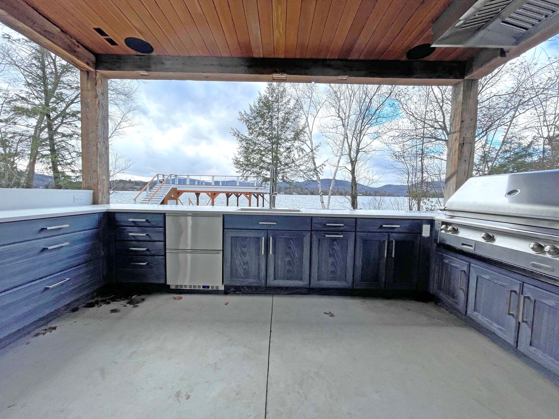 A kitchen with a grill and a view of a lake