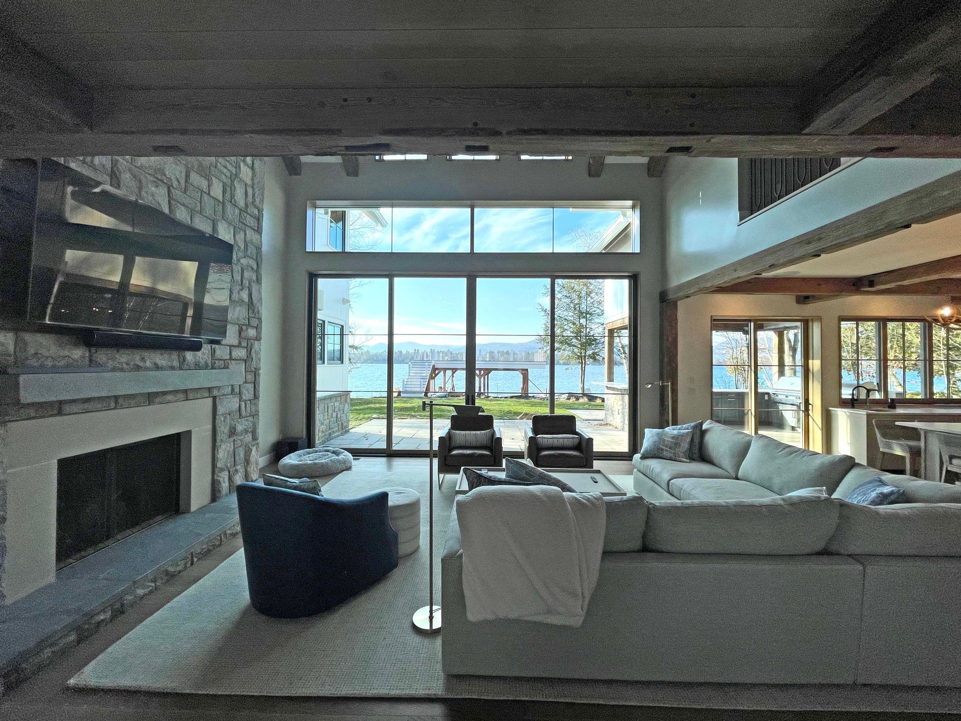 A living room with a couch , chairs , fireplace and television.