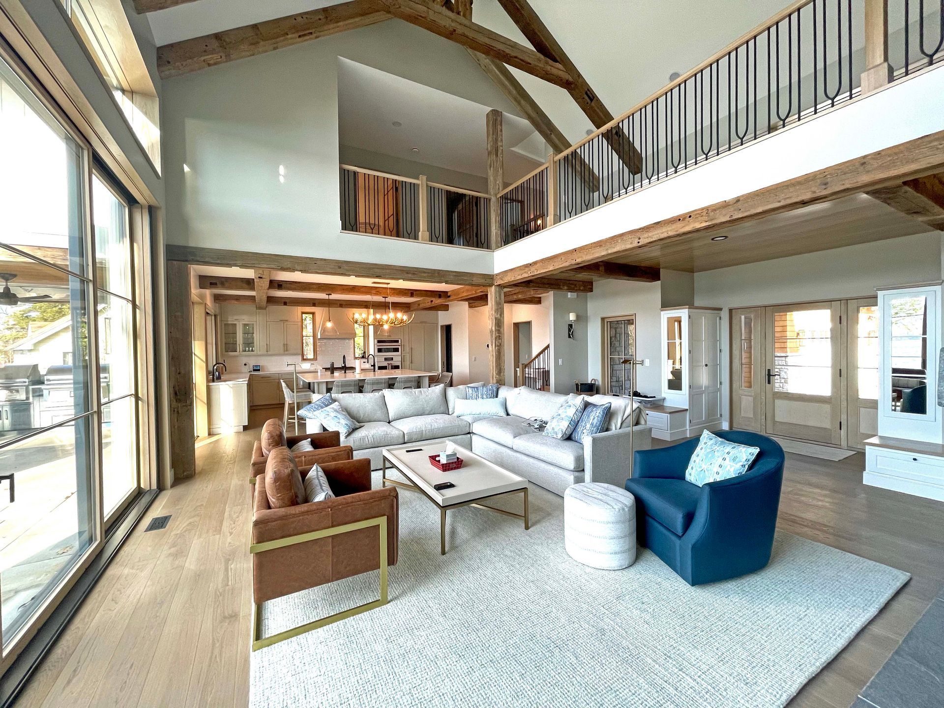 A living room with a lot of furniture and a balcony.
