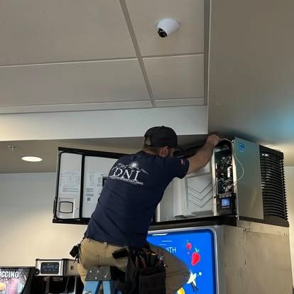 Stainless steel commercial freezer with open door and visible shelves, emitting cool mist.