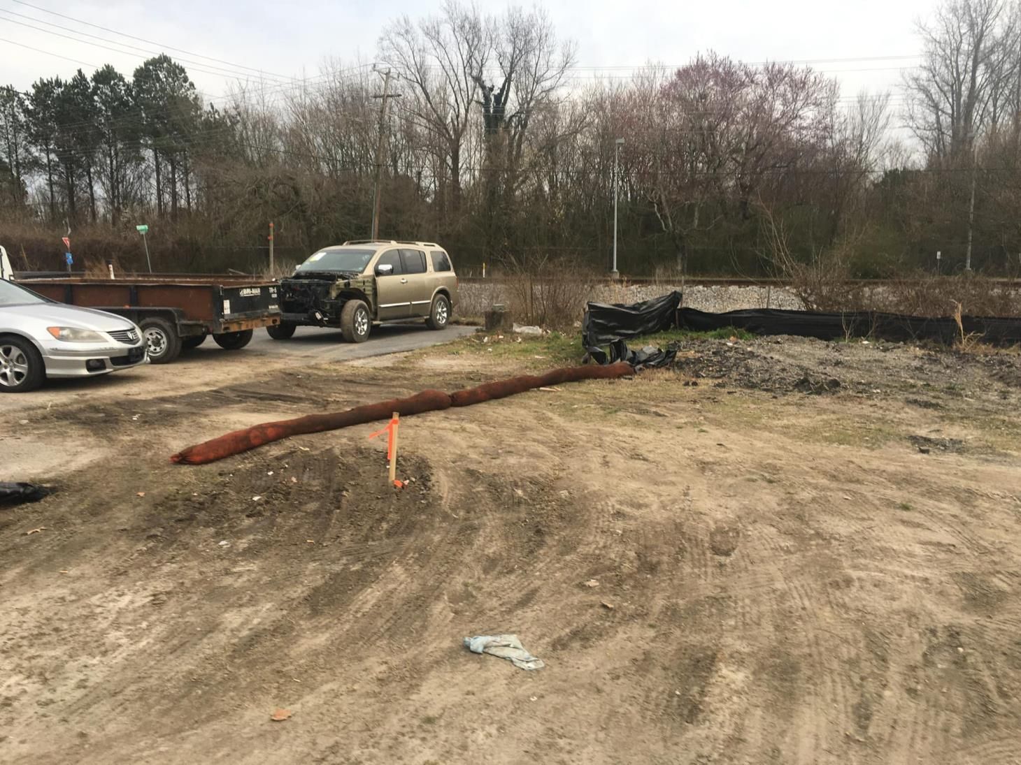 A large yellow excavator is demolishing a building.
