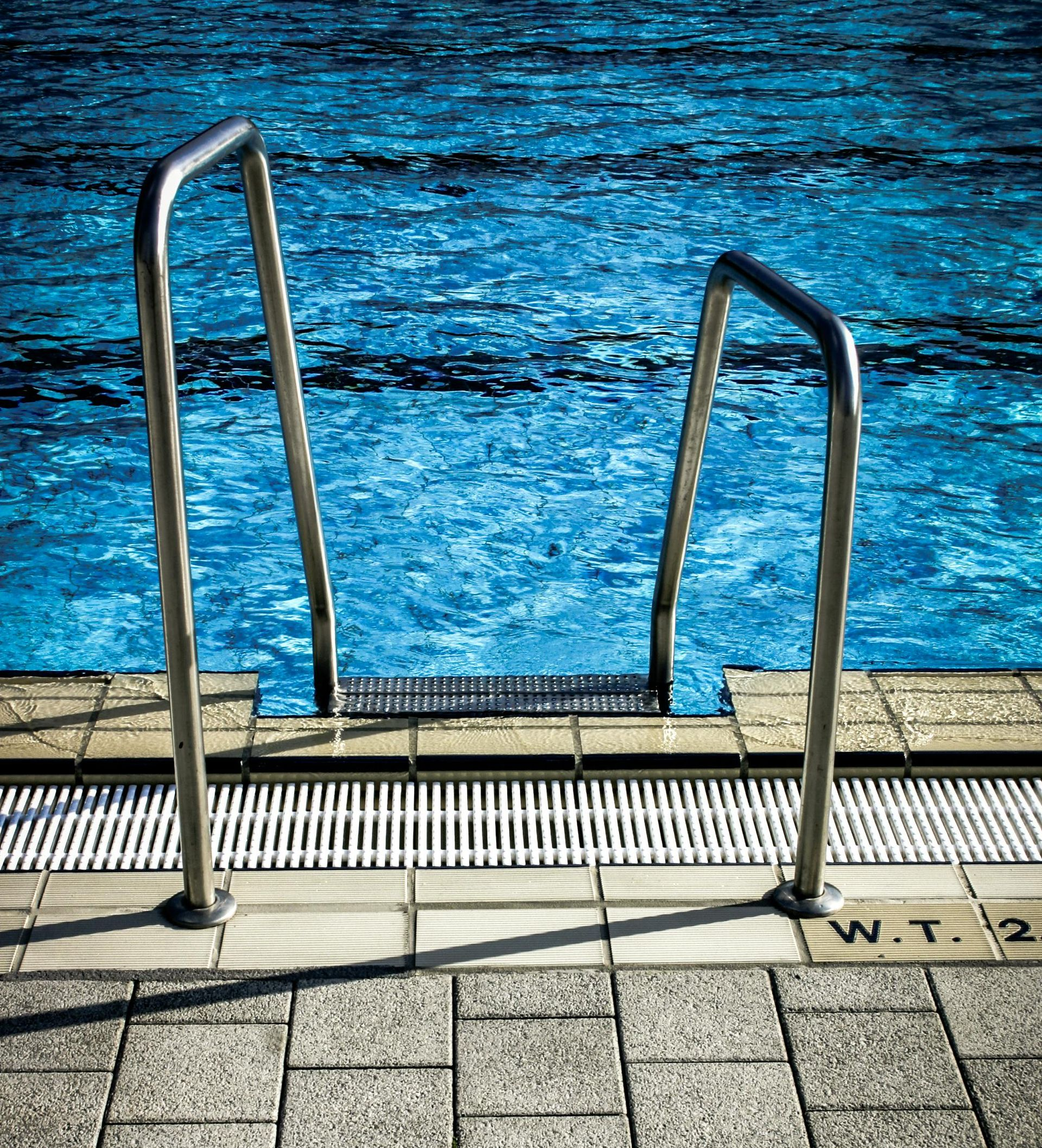 A bulldozer is demolishing a building with a large bucket.