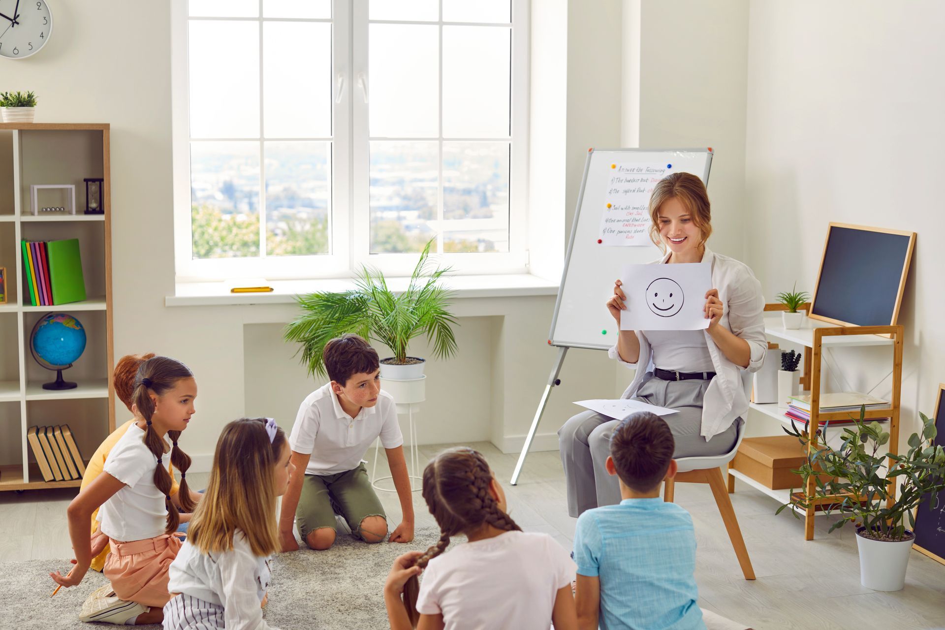 A teacher is teaching a group of children in a classroom.