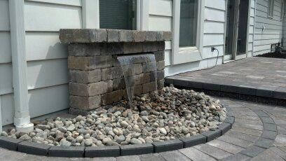 A waterfall is built into the side of a house.