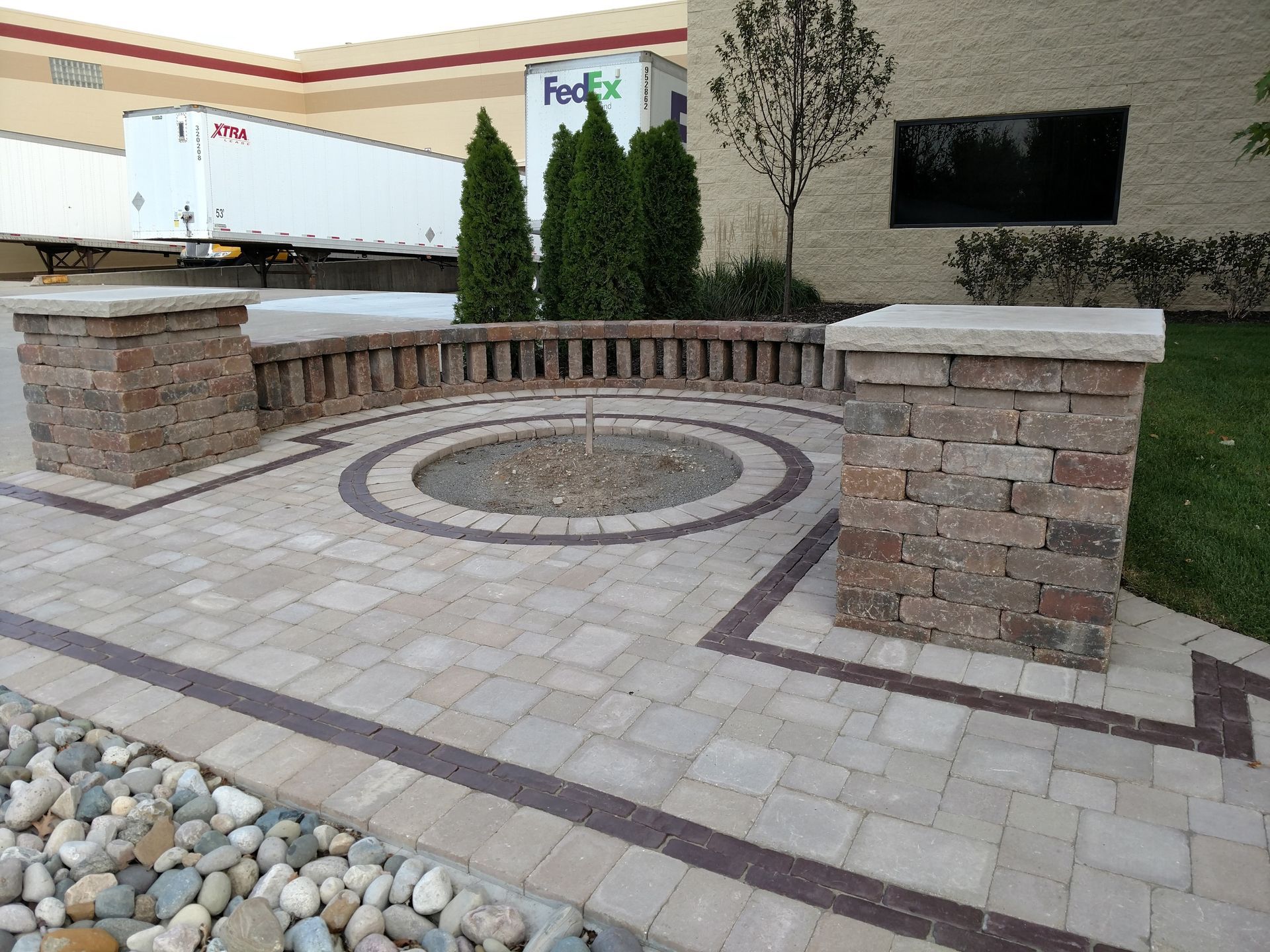A restaurant with tables and chairs and a green wall.