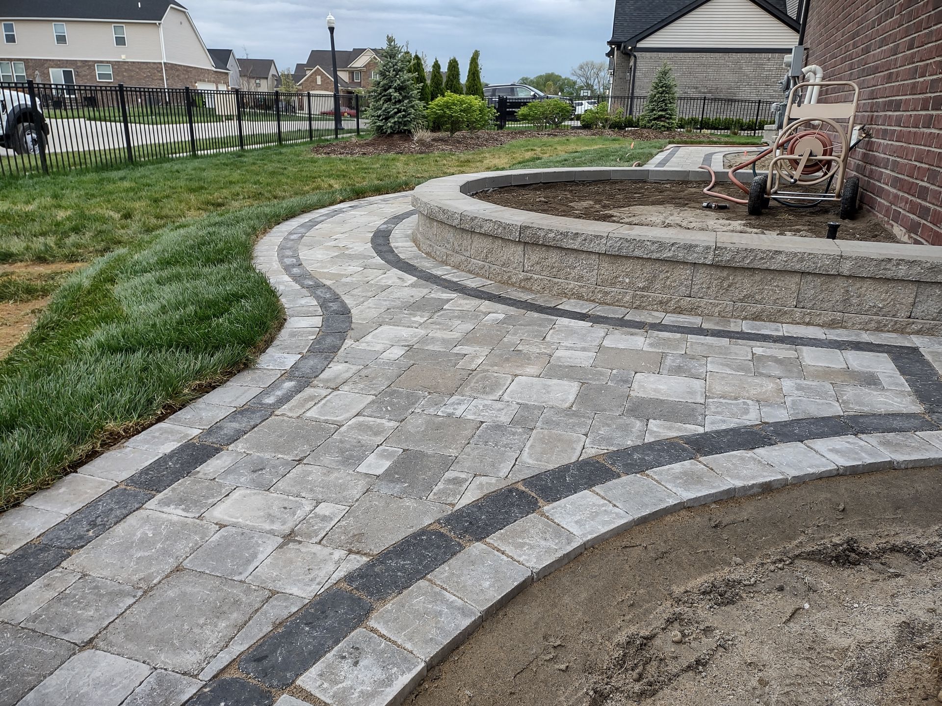 A brick walkway leading to the front door of a brick house.